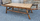Grande table basse en bambou, fixations en rotin, plateau imitation bois clair, en excellent état de conservation. Pour ajouter une touche ethnique à votre décoration, à utiliser en table de salon ou bout de lit.